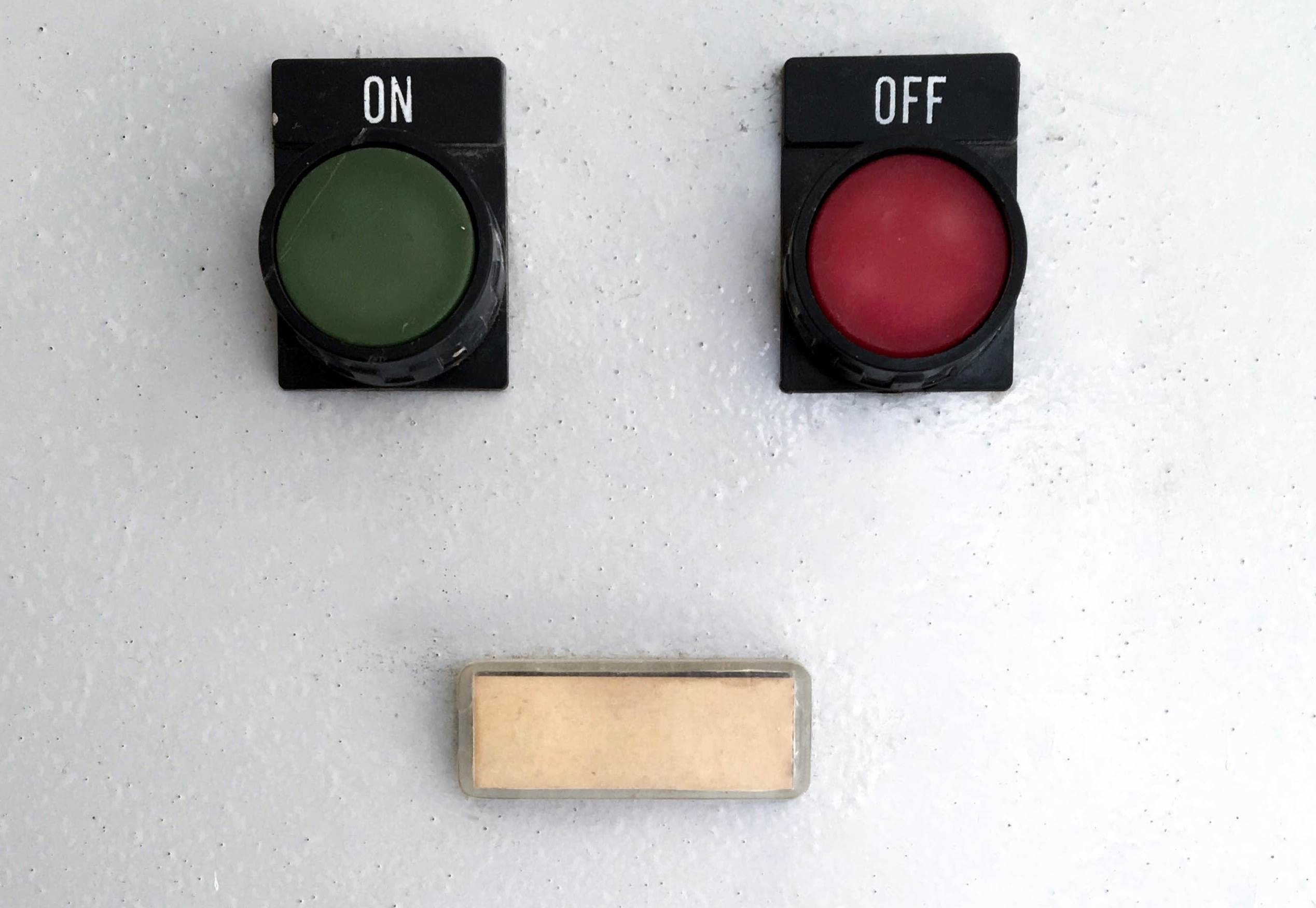 A wall with an on button and an off button.